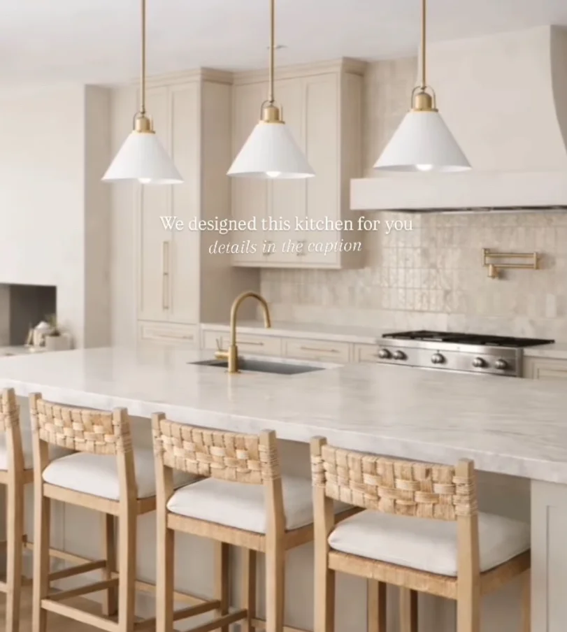 Modern kitchen with white cabinetry, quartz countertops, brass pendants, and woven wood bar seating